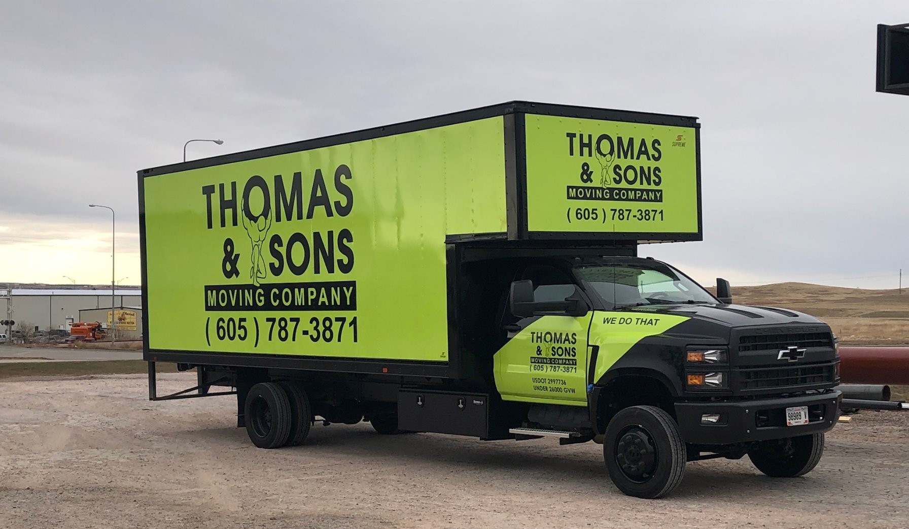 265221363_7025549134129822_901844538888369832_n (2) A truck with the thomas and sons moving company logo on it.