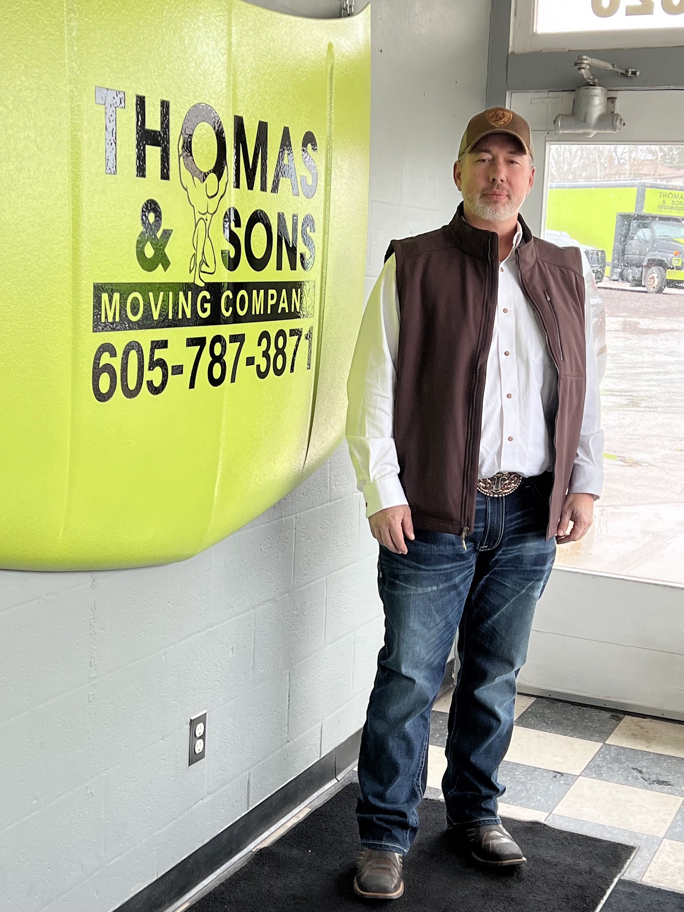 A man standing near the SMB’s logo on a wall